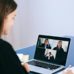 woman sitting at laptop on a zoom/MS teams call