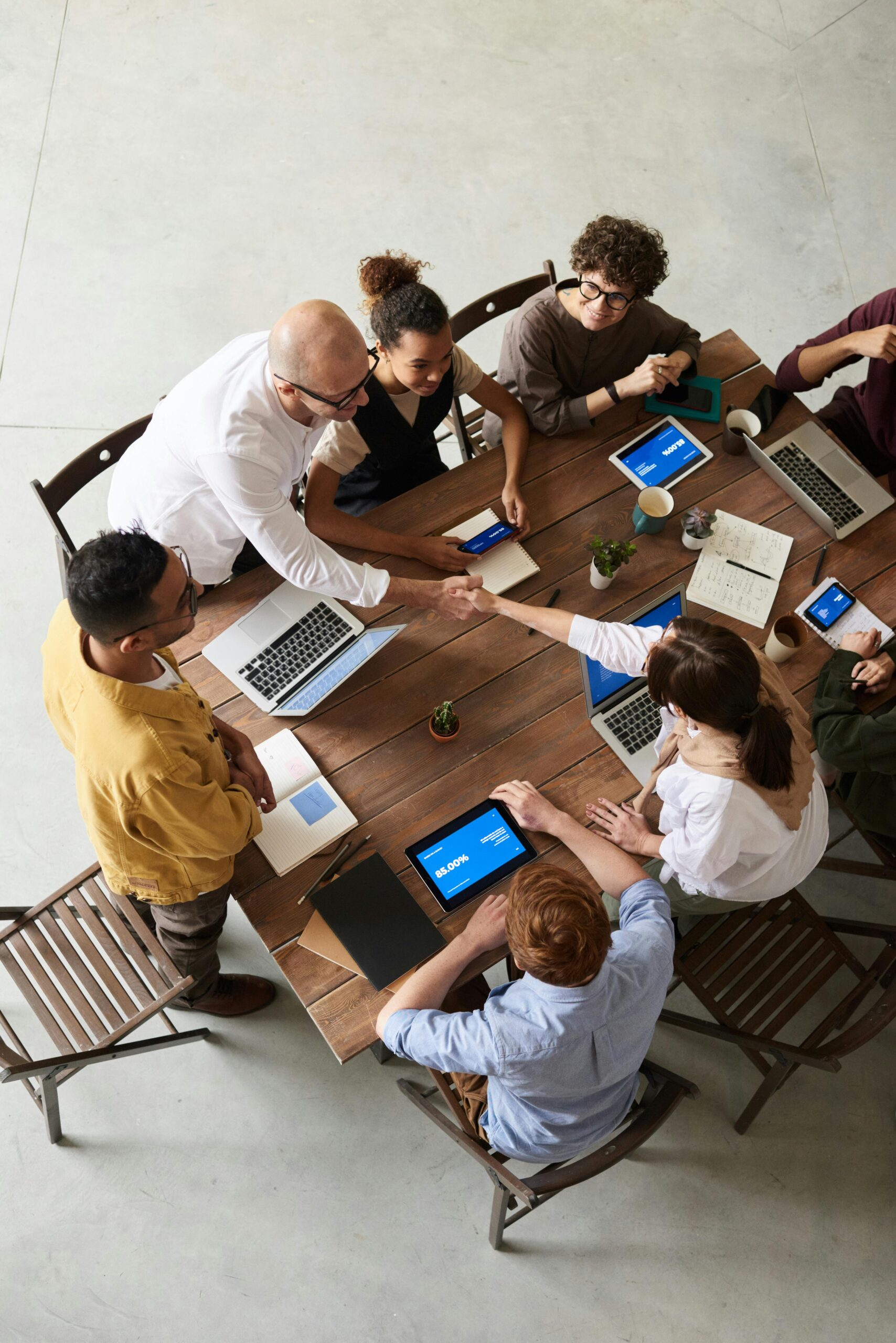 group of people meeting at a table, photo from above